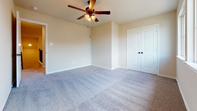 unfurnished bedroom featuring a closet, baseboards, and carpet flooring