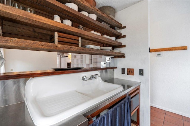 interior space with baseboards and a sink