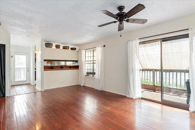 unfurnished living room featuring a textured ceiling and hardwood / wood-style floors