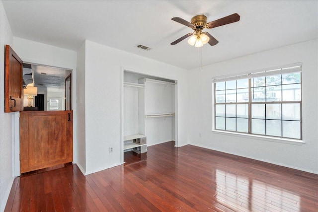 2215 Post Rd Unit 2029, Austin, TX 78704 - unfurnished bedroom featuring a closet, hardwood / wood-style floors, a ceiling fan, and baseboards