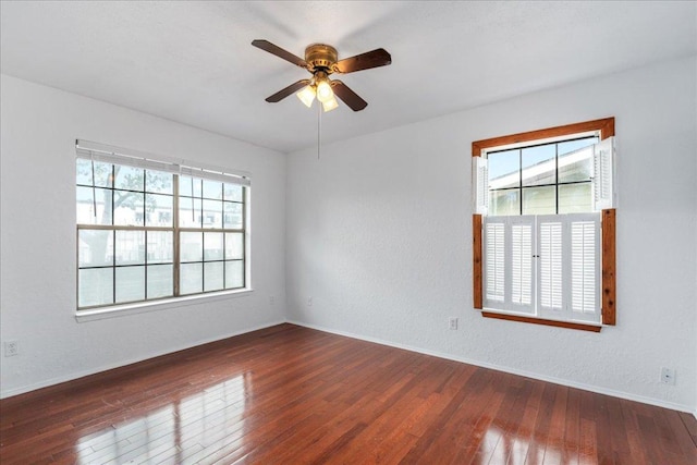 empty room featuring ceiling fan, baseboards, and hardwood / wood-style flooring