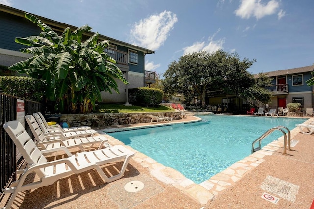 community pool with a patio area