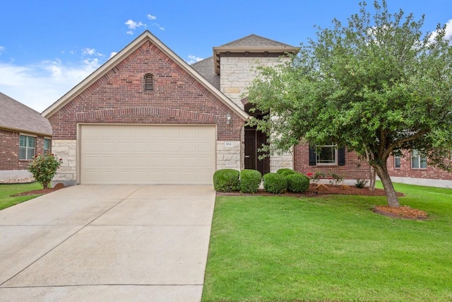 104 N Pasture Cv, Hutto, TX 78634 - view of front of home with stone siding, a front lawn, concrete driveway, and an attached garage