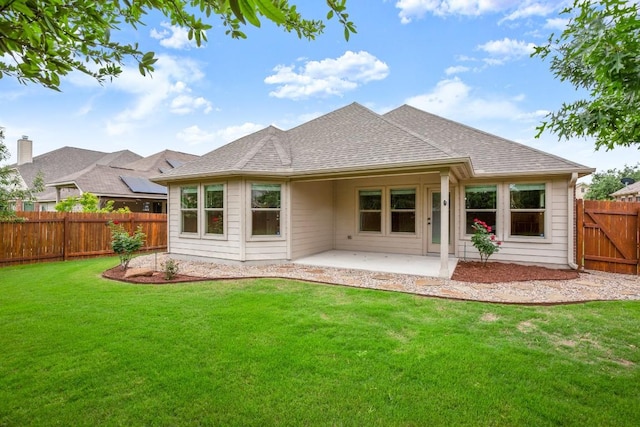 104 N Pasture Cv, Hutto, TX 78634 - rear view of house with a patio area and a shingled roof