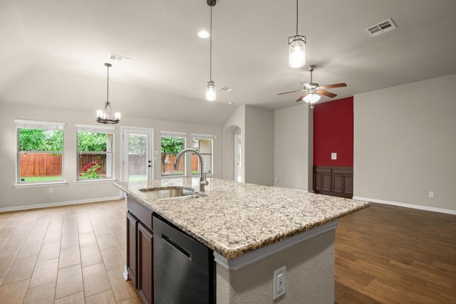 104 N Pasture Cv, Hutto, TX 78634 - kitchen with a sink, stainless steel dishwasher, arched walkways, lofted ceiling, and open floor plan