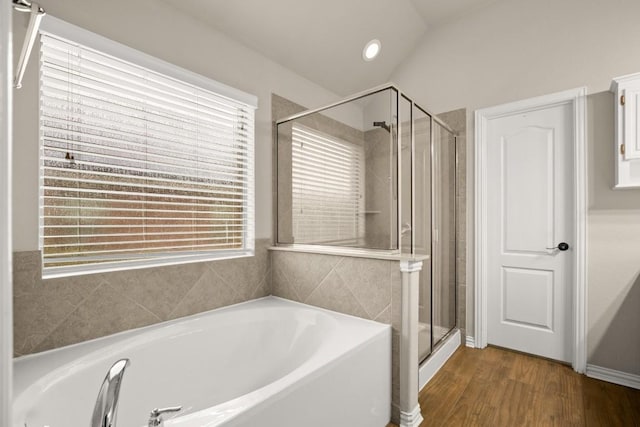 104 N Pasture Cv, Hutto, TX 78634 - bathroom with a bath, a shower stall, and wood finished floors