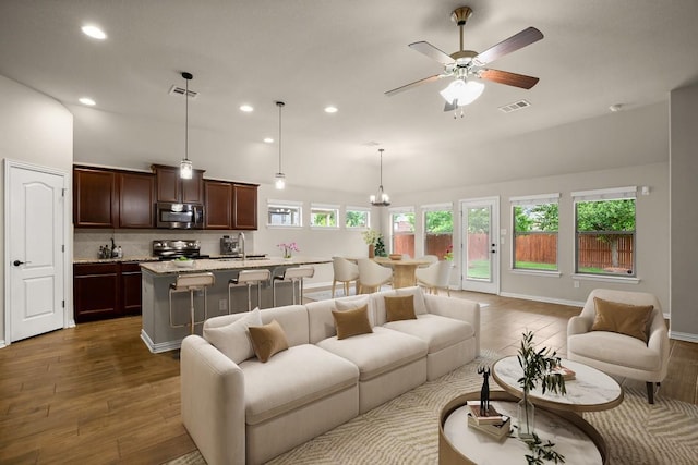 104 N Pasture Cv, Hutto, TX 78634 - living room with wood finished floors, recessed lighting, ceiling fan, and baseboards