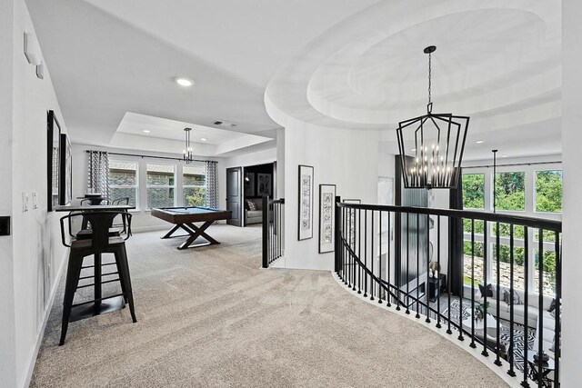 1220 Summer Moon Dr, Georgetown, TX 78628 - hall with a tray ceiling, a chandelier, carpet floors, an upstairs landing, and recessed lighting