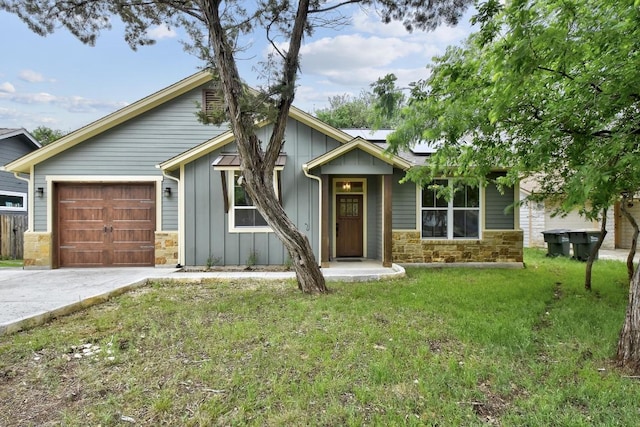 view of front of property featuring a garage, board and batten siding, driveway, and stone siding