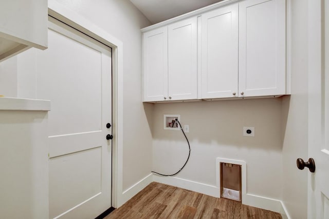 washroom featuring electric dryer hookup, cabinet space, wood finished floors, baseboards, and hookup for a washing machine