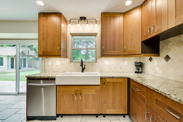 kitchen with a healthy amount of sunlight, a sink, tasteful backsplash, and dishwasher