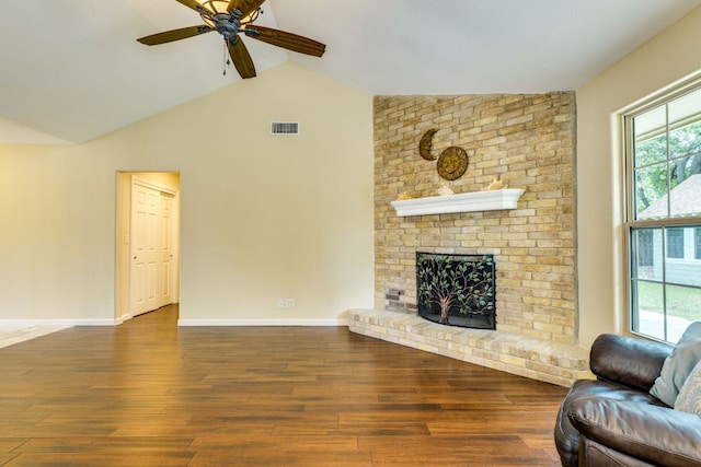 1307 S Meadows Dr, Austin, TX 78758 - living area with vaulted ceiling, wood finished floors, ceiling fan, a fireplace, and baseboards