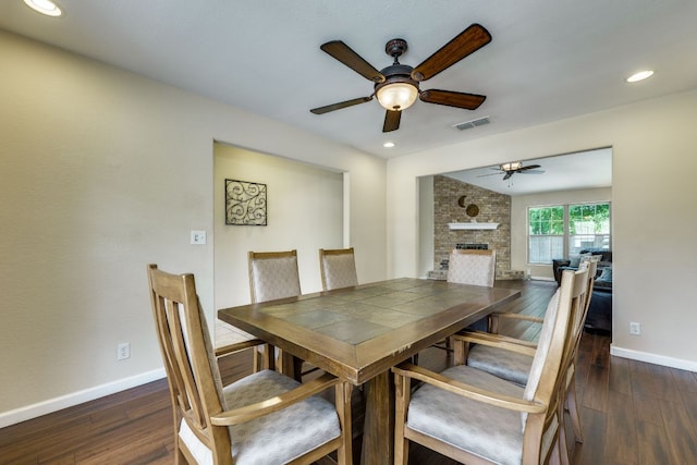 1307 S Meadows Dr, Austin, TX 78758 - dining room featuring a ceiling fan, dark wood-type flooring, baseboards, a fireplace, and recessed lighting