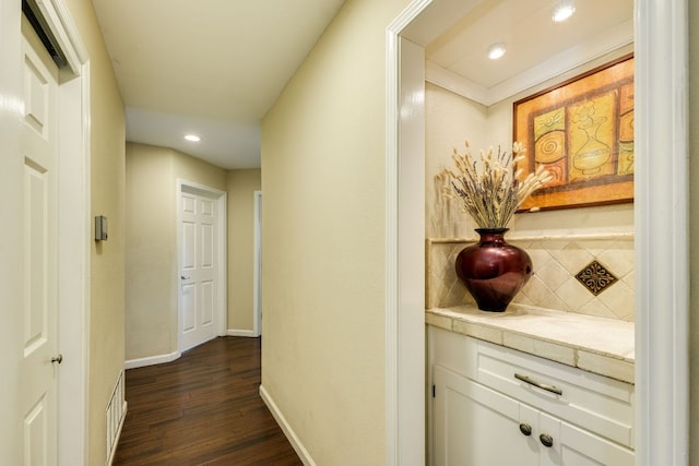 corridor with recessed lighting, baseboards, and dark wood-style flooring