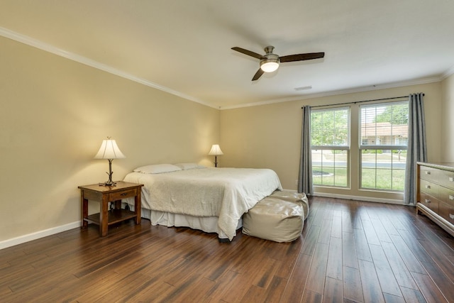 bedroom with baseboards, ornamental molding, dark wood-style floors, and ceiling fan