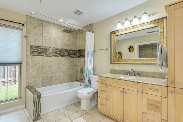 1307 S Meadows Dr, Austin, TX 78758 - full bathroom featuring tile patterned floors, shower / tub combo with curtain, vanity, and toilet
