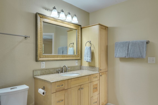 bathroom with vanity and toilet