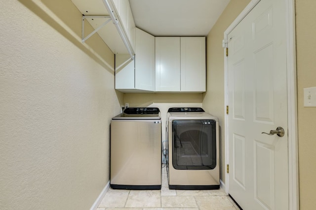 1307 S Meadows Dr, Austin, TX 78758 - laundry room with cabinet space, washer and clothes dryer, baseboards, and a textured wall