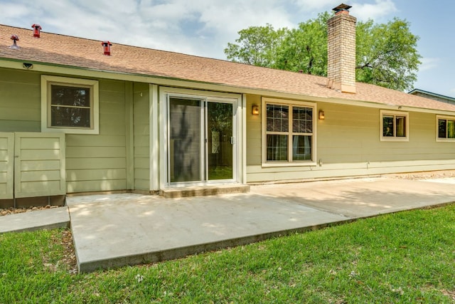 back of property with a patio and a chimney