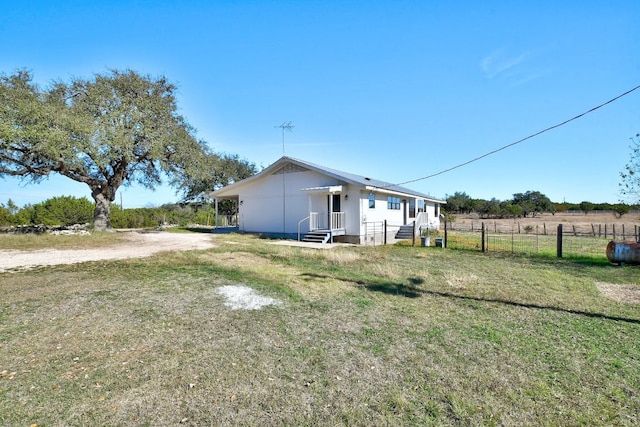 exterior space with fence and a yard