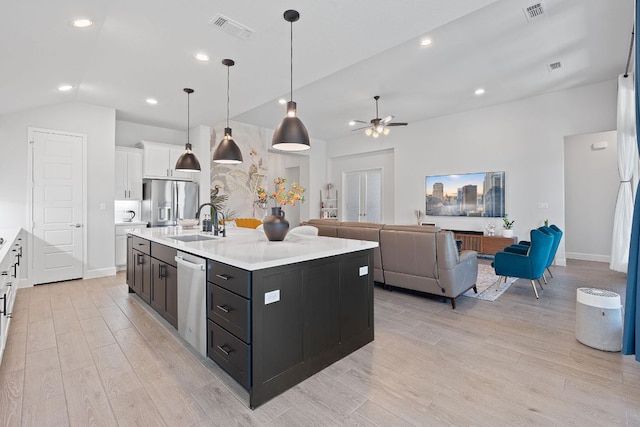 1504 Caylea Bluff Ln, Georgetown, TX 78628 - kitchen featuring stainless steel appliances, white cabinetry, light countertops, light wood-style floors, and lofted ceiling