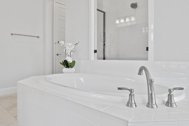1504 Caylea Bluff Ln, Georgetown, TX 78628 - full bathroom featuring a bath, marble finish flooring, and a shower stall