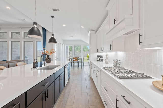 1504 Caylea Bluff Ln, Georgetown, TX 78628 - kitchen featuring appliances with stainless steel finishes, light countertops, white cabinets, backsplash, and recessed lighting