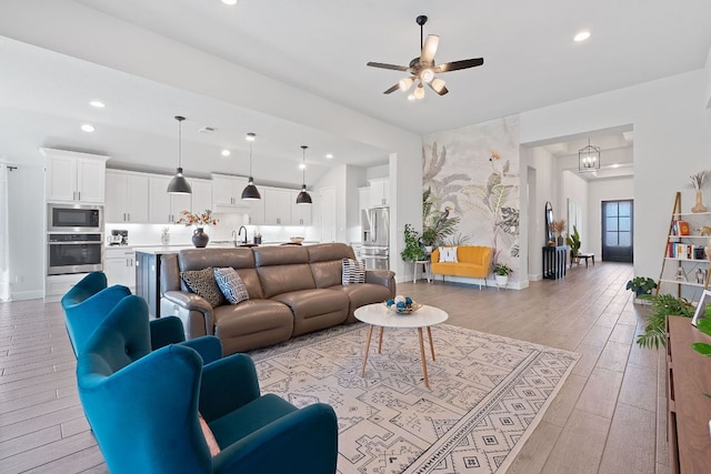 living area with recessed lighting, ceiling fan, baseboards, and light wood-style floors