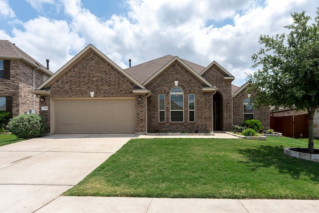view of front facade with concrete driveway, brick siding, an attached garage, and a front lawn