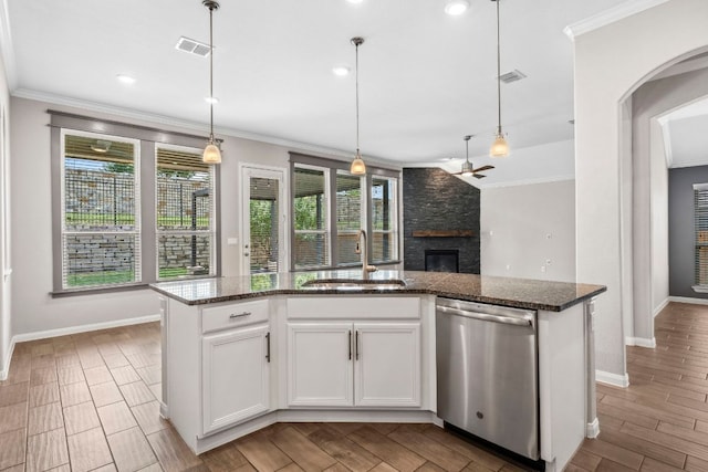 12509 Morelia Way, Austin, TX 78748 - kitchen with visible vents, stainless steel dishwasher, a fireplace, a sink, and baseboards