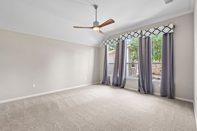 carpeted spare room featuring crown molding, a ceiling fan, baseboards, and lofted ceiling