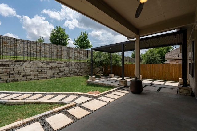 view of patio with a fenced backyard and ceiling fan