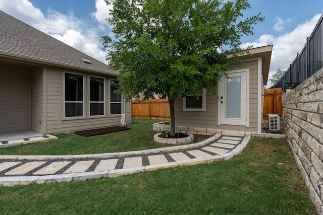 view of yard with an outdoor structure, ac unit, and a fenced backyard