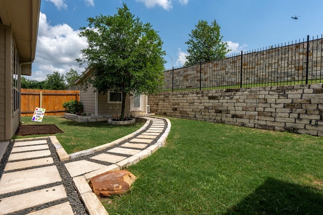 view of yard featuring an outdoor structure and a fenced backyard