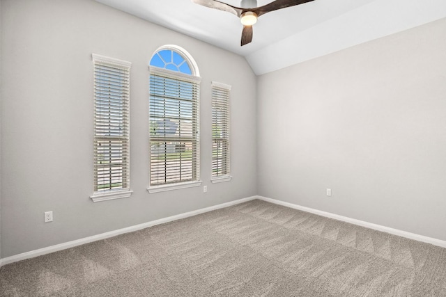 unfurnished room featuring carpet floors, a ceiling fan, baseboards, and vaulted ceiling