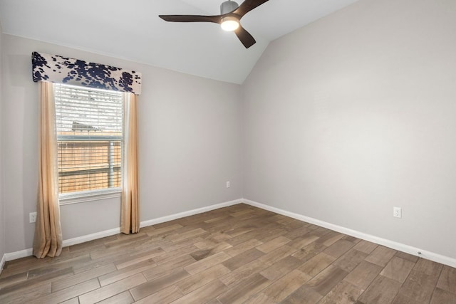 unfurnished room featuring baseboards, light wood finished floors, ceiling fan, and lofted ceiling
