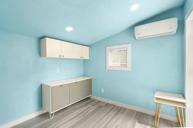 12509 Morelia Way, Austin, TX 78748 - laundry area with recessed lighting, baseboards, a wall unit AC, and light wood-style flooring