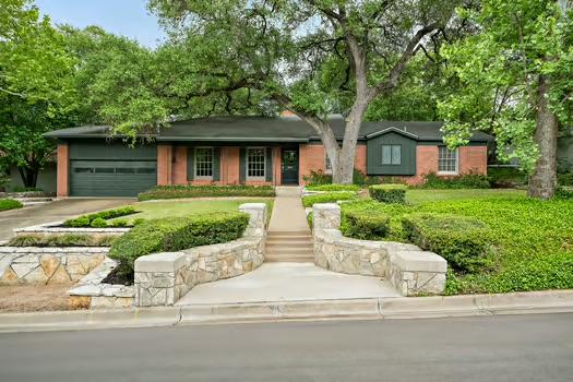 ranch-style home with a garage and driveway