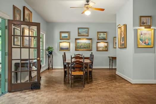 dining area featuring baseboards and ceiling fan