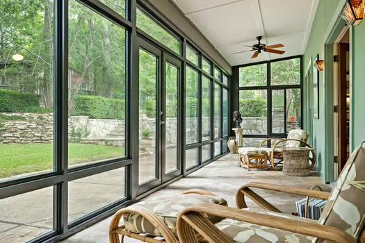 sunroom / solarium featuring ceiling fan