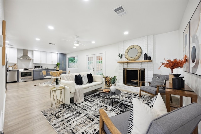 living area with recessed lighting, ceiling fan, light wood-type flooring, and visible vents