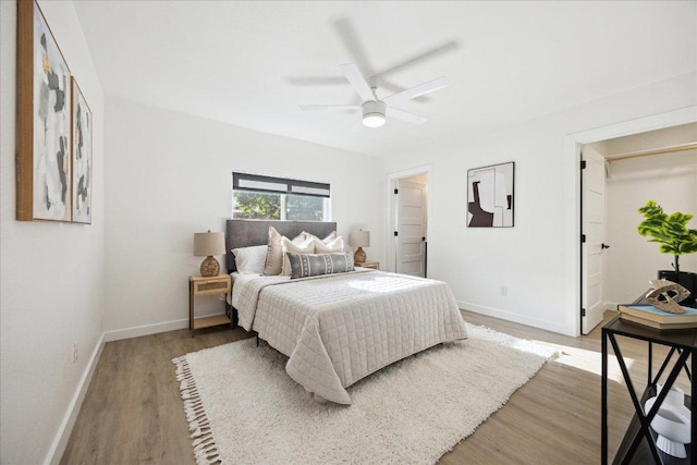 bedroom with baseboards, ceiling fan, and wood finished floors