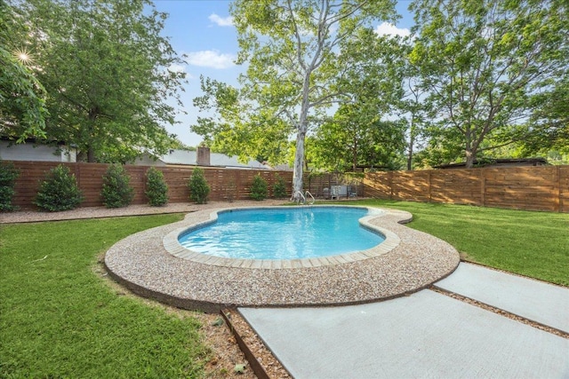 view of pool featuring a lawn, a fenced in pool, and a fenced backyard