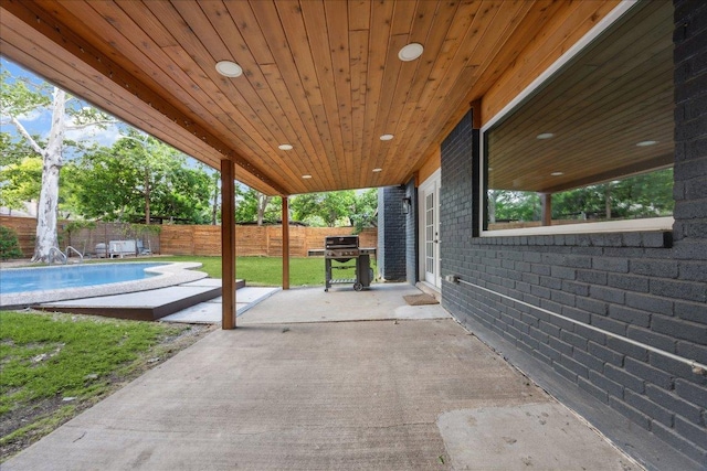view of patio / terrace with a fenced in pool, a fenced backyard, and area for grilling