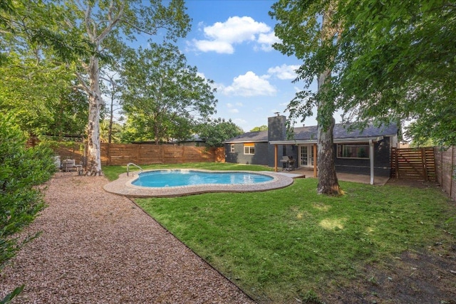 view of pool featuring french doors, a fenced in pool, a fenced backyard, a lawn, and a patio