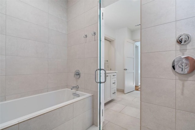 2902 Cedarview Dr, Austin, TX 78704 - full bath featuring tile patterned flooring, visible vents, vanity, tile walls, and tiled shower / bath combo