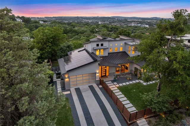 2902 Cedarview Dr, Austin, TX 78704 - view of front of property featuring a standing seam roof, metal roof, a garage, fence, and concrete driveway