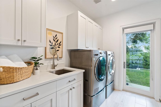 2902 Cedarview Dr, Austin, TX 78704 - laundry area featuring cabinet space, separate washer and dryer, and light tile patterned flooring