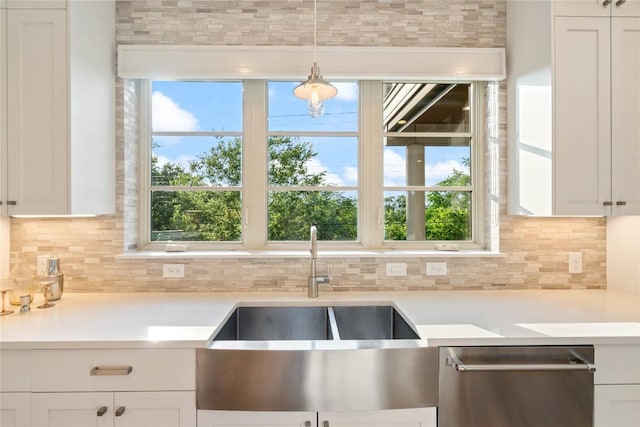2902 Cedarview Dr, Austin, TX 78704 - kitchen with light countertops, white cabinetry, tasteful backsplash, a sink, and dishwasher