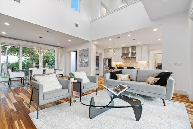 2902 Cedarview Dr, Austin, TX 78704 - living area with light wood-style floors, a high ceiling, and recessed lighting